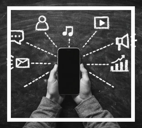 Person holding phone with digital marketing symbols